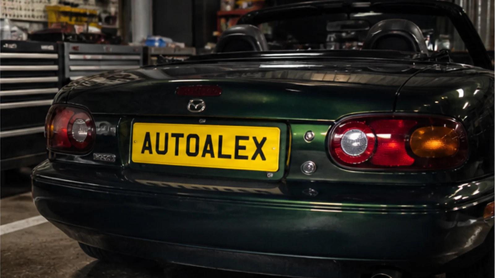 Mazda MX-5 in a workshop with an AutoAlex-inspired number plate
